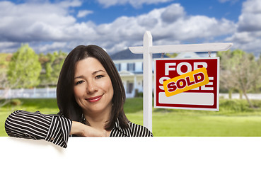 Image showing Hispanic Woman in Front of Sold For Sale Sign, House