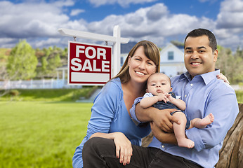 Image showing Young Family in Front of For Sale Sign and House