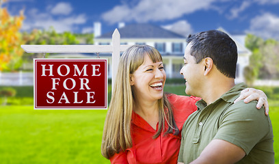 Image showing Couple in Front of For Sale Sign and House