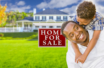 Image showing Father and Son In Front of Sale Sign and House