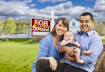 Image showing Young Family in Front of Sold Real Estate Sign and House