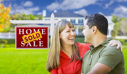 Image showing Couple in Front of Sold Real Estate Sign and House