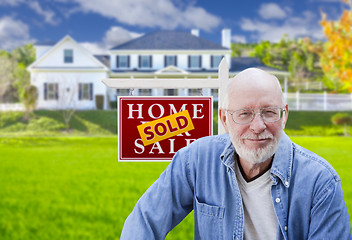 Image showing Senior Adult Man in Front of Real Estate Sign, House