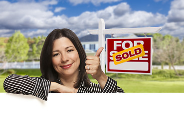 Image showing Hispanic Woman in Front of Sold For Sale Sign, House