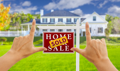 Image showing Hands Framing Sold For Sale Real Estate Sign and House