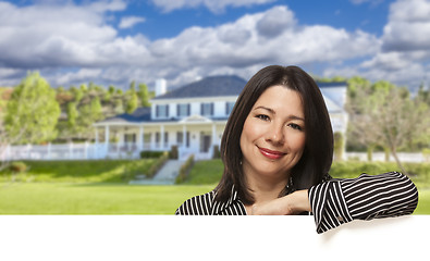 Image showing Hispanic Woman Leaning on White in Front of House