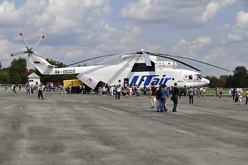 Image showing People consider the helicopter of the UTair company at an air sh