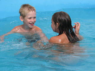 Image showing Children swim in the pool.