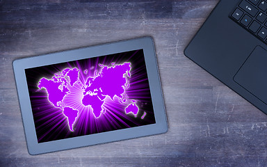 Image showing World map on a tablet