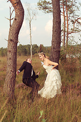 Image showing Bride threatens your wedded husband with a stick