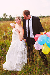 Image showing Funny wedding couple with balloons