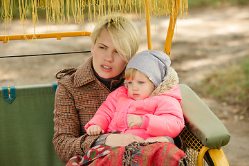 Image showing Beautiful Mother And Baby outdoors. Nature. Beauty Mum and her Child playing in Park together. Outdoor Portrait of happy family. Joy.