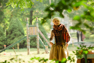 Image showing Portrait of young attractive woman at green park.