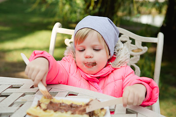 Image showing Child eating waffles with chocolate 