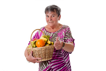 Image showing Senior woman with basket of fruit