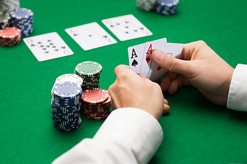 Image showing poker player with cards and chips at casino