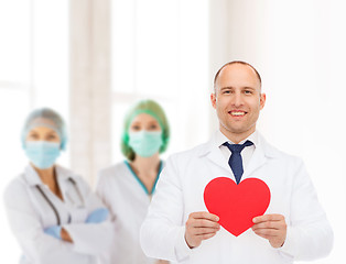 Image showing smiling male doctor with red heart