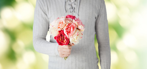 Image showing close up of man holding flowers