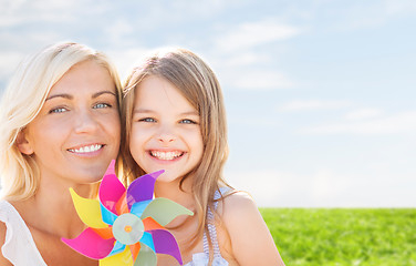 Image showing happy mother and little girl with pinwheel toy