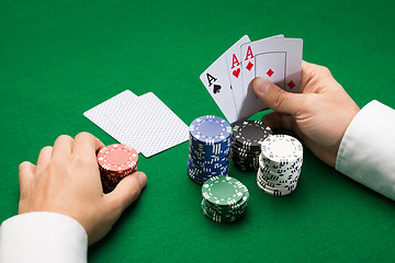 Image showing poker player with cards and chips at casino