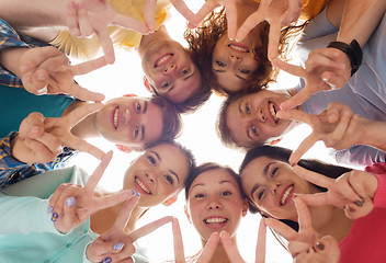 Image showing group of smiling teenagers showing victory sign