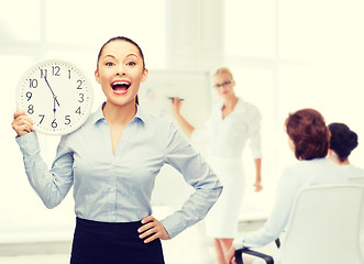 Image showing attractive businesswoman with wall clock