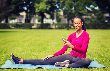 Image showing smiling african american woman with smartphone