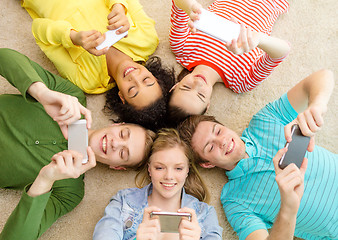 Image showing group of smiling people lying down on floor