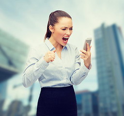 Image showing screaming businesswoman with smartphone