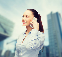 Image showing young smiling businesswoman with smartphone