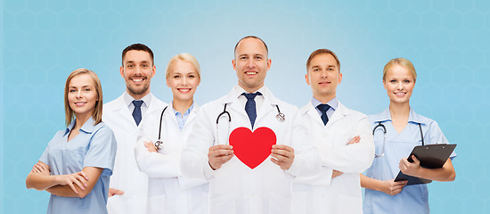 Image showing group of smiling doctors with red heart shape