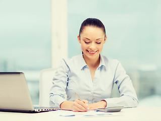 Image showing businesswoman working with documents in office