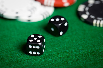 Image showing close up of black dices on green casino table