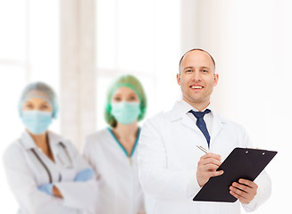 Image showing smiling male doctor with clipboard