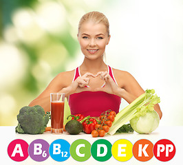 Image showing happy woman with organic food and vitamins