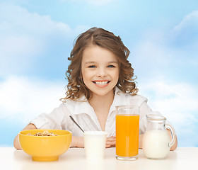 Image showing happy girl eating healthy breakfast