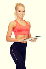 Image showing smiling sporty woman with tablet pc computer