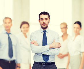 Image showing handsome businessman with crossed arms