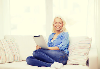 Image showing smiling woman with tablet pc computer at home