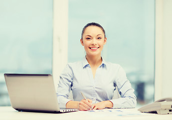 Image showing businesswoman with phone, laptop and files