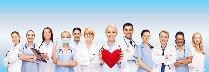 Image showing smiling doctors and nurses with red heart