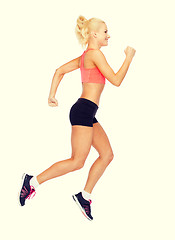 Image showing sporty woman running or jumping