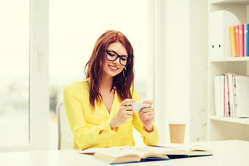 Image showing smiling student girl with smartphone at school