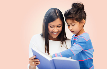 Image showing happy mother and daughter reading book