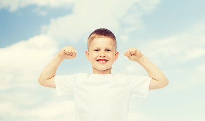 Image showing happy little boy in white t-shirt flexing biceps