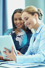 Image showing smiling businesswomen with tablet pc in office