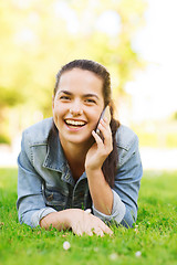 Image showing laughing young girl lying on grass