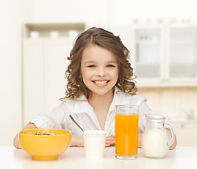 Image showing happy girl eating healthy breakfast