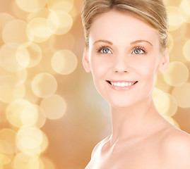 Image showing close up of smiling woman over beige background