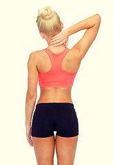 Image showing sporty woman touching her neck